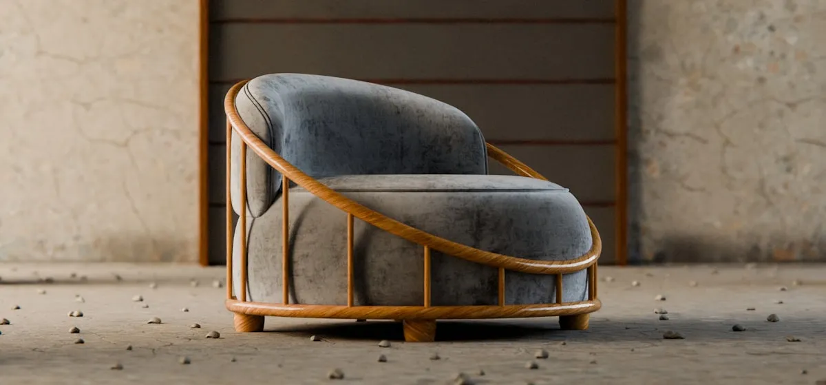 Grey velvet armchair enclosed by a curved steam-bent oak slat frame that wraps around the back and arms like a basket, on a bare textured floor.