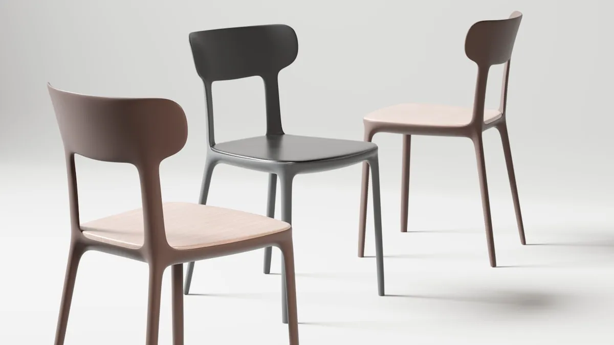 Three matte-finish dining chairs in graphite, taupe, and grey shown from behind, each with a curved solid backrest and light wood seat, on a plain grey studio background.