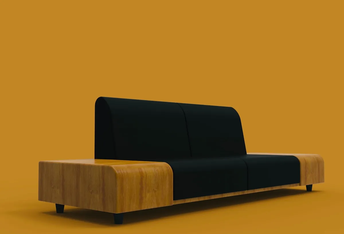 Rendered product shot of a low modular sofa unit with a black upholstered seat and back set into a light wood base, on a solid mustard-orange background.
